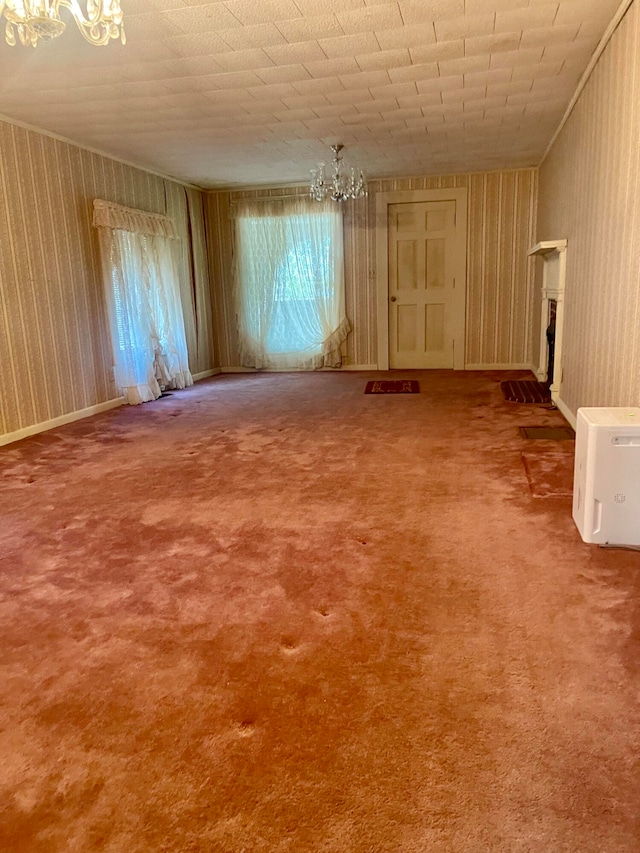 carpeted spare room with a chandelier and a wealth of natural light