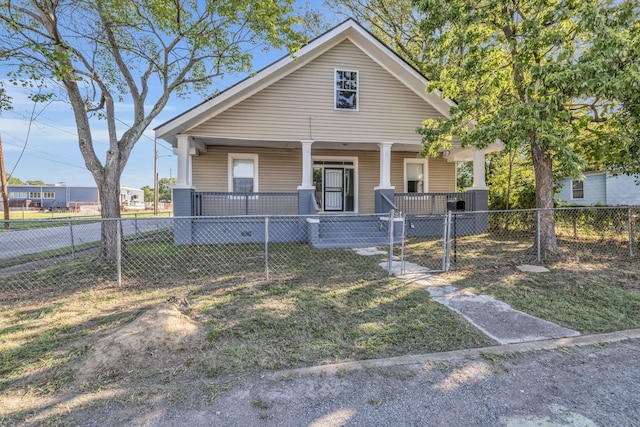 bungalow-style home featuring a front yard and covered porch