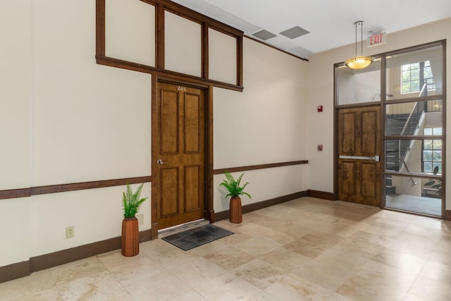 entrance foyer featuring visible vents, stairs, and baseboards