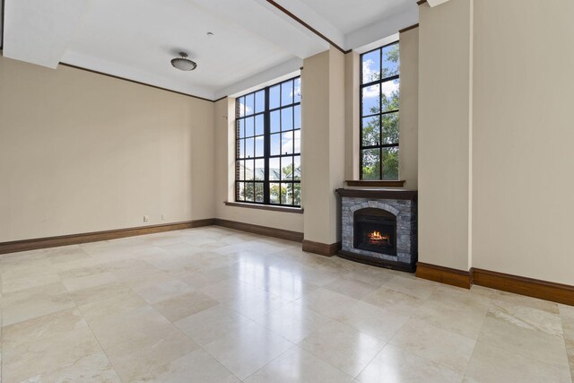 unfurnished living room featuring a stone fireplace