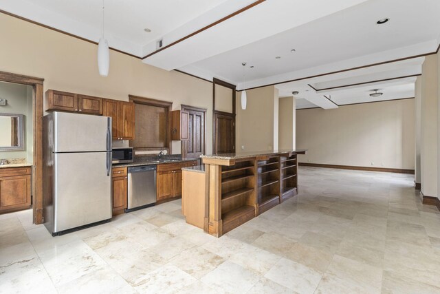 kitchen with dark stone counters, stainless steel appliances, a kitchen island, sink, and hanging light fixtures