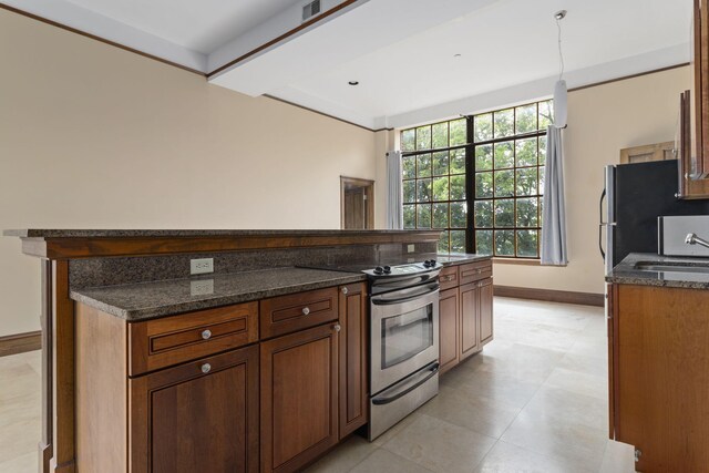 kitchen with hanging light fixtures, stainless steel appliances, dark stone countertops, and sink