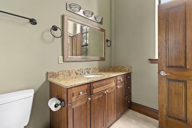 bathroom featuring vanity, toilet, and tile patterned floors