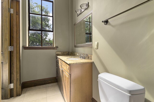 bathroom featuring vanity, toilet, and tile patterned floors