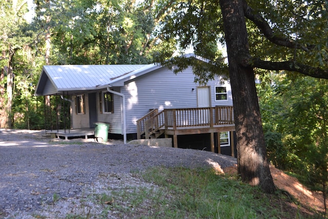 view of front of property featuring a deck and metal roof