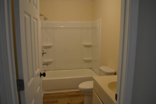 full bathroom featuring vanity, toilet, hardwood / wood-style flooring, and shower / washtub combination