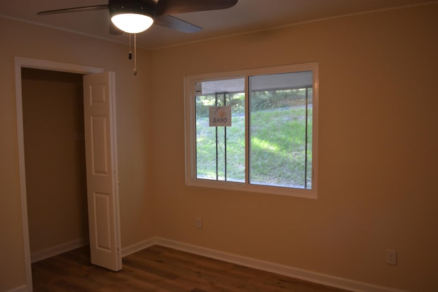 unfurnished bedroom featuring dark hardwood / wood-style flooring and ceiling fan