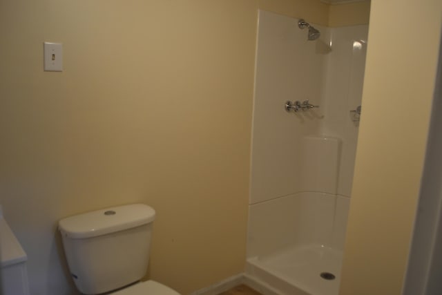 bathroom featuring toilet and walk in shower