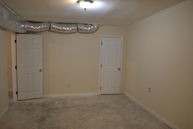 basement with carpet, crown molding, and a textured ceiling