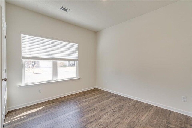 unfurnished room featuring wood-type flooring