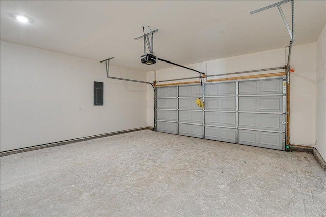 garage with a garage door opener and electric panel