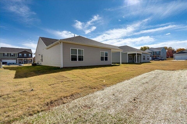 rear view of house featuring a yard