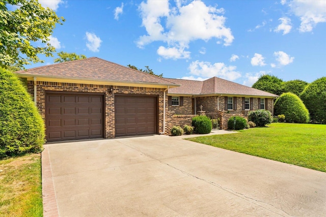 ranch-style home featuring a front lawn and a garage