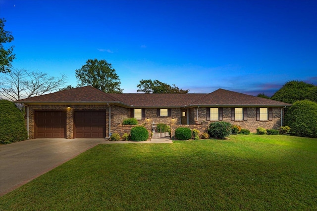 ranch-style home featuring a yard and a garage