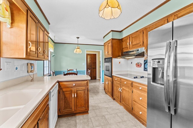 kitchen featuring pendant lighting, ornamental molding, stainless steel appliances, sink, and decorative backsplash