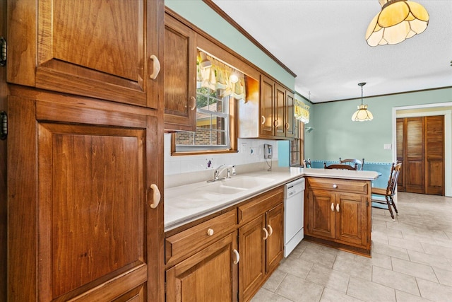 kitchen with decorative light fixtures, dishwasher, light tile patterned floors, kitchen peninsula, and sink