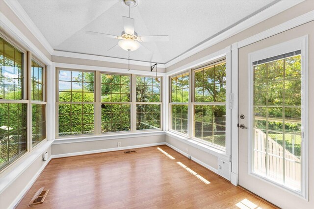 unfurnished sunroom with a healthy amount of sunlight and ceiling fan