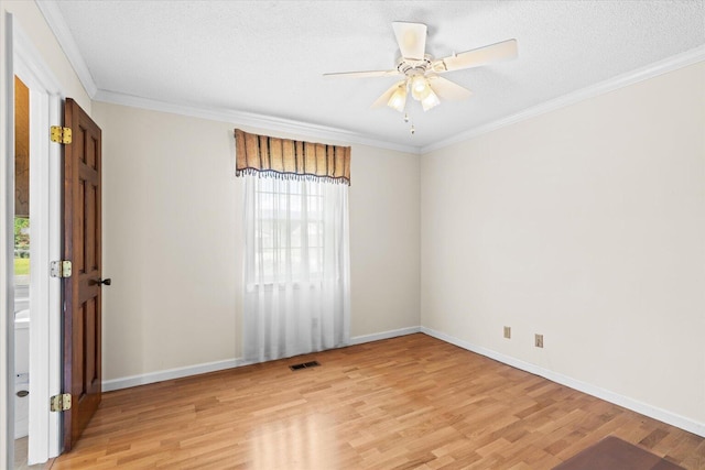 spare room featuring ornamental molding, a textured ceiling, light hardwood / wood-style flooring, and ceiling fan