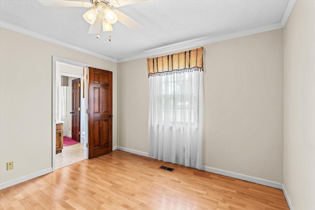 unfurnished room with ornamental molding, light hardwood / wood-style flooring, and ceiling fan