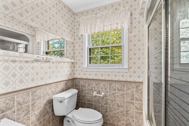 bathroom with toilet and an enclosed shower