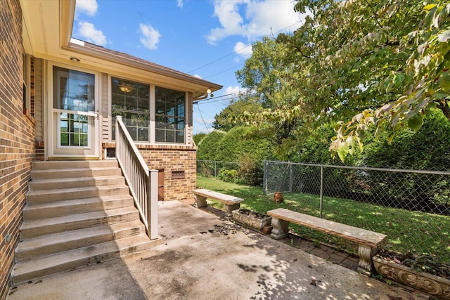 view of exterior entry with a patio area