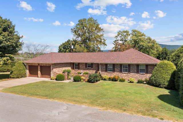 ranch-style house featuring a garage and a front lawn