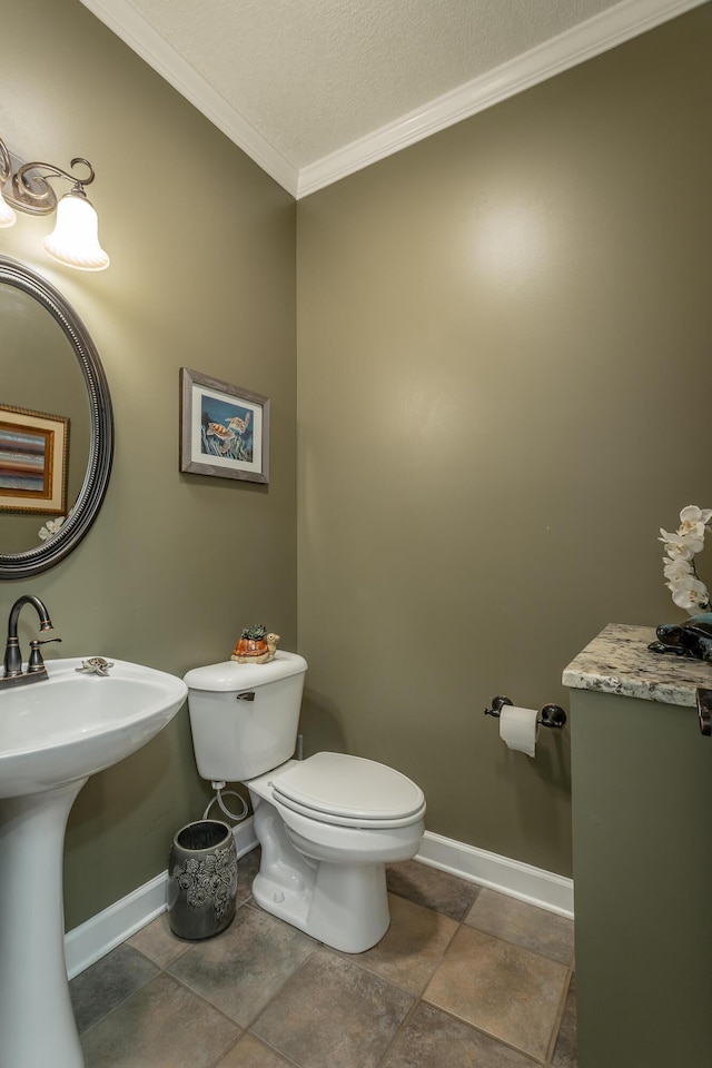 bathroom with a textured ceiling, toilet, crown molding, and sink