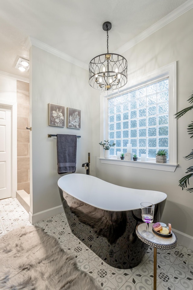 bathroom with tile patterned flooring, a bathtub, ornamental molding, and a chandelier