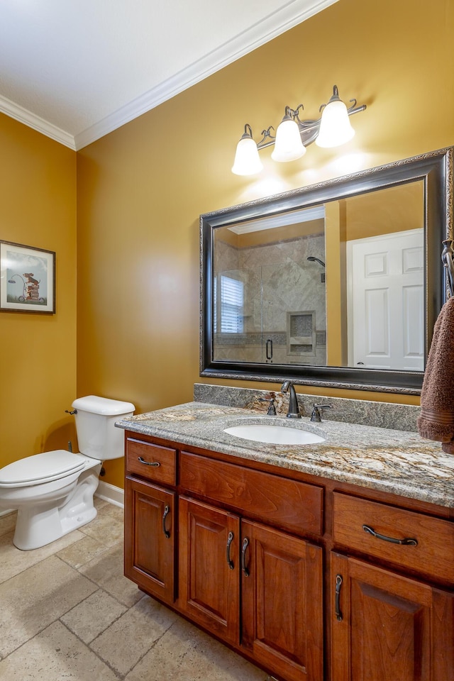 bathroom with vanity, toilet, a shower with shower door, and ornamental molding