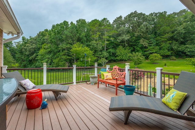 wooden terrace featuring a lawn