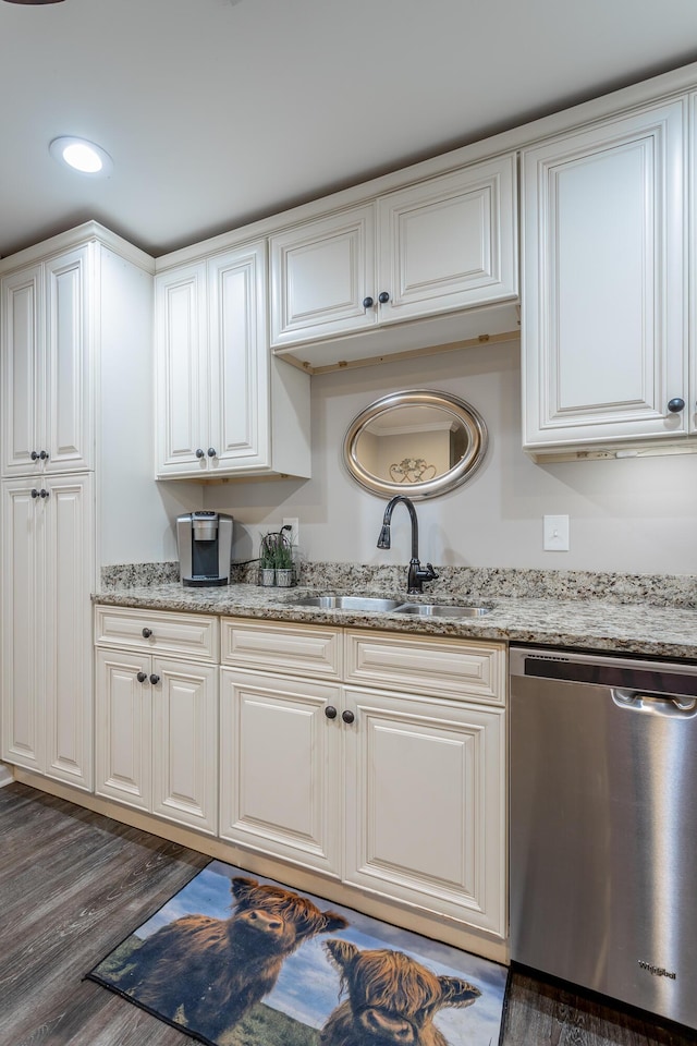 kitchen featuring dishwasher, dark hardwood / wood-style floors, light stone countertops, and sink