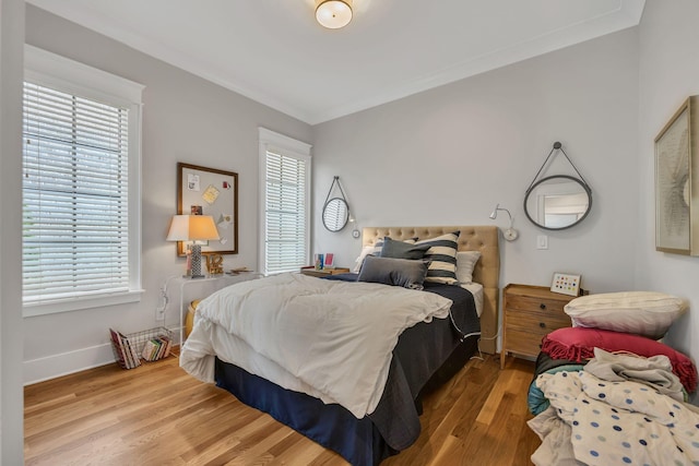 bedroom featuring crown molding and hardwood / wood-style floors