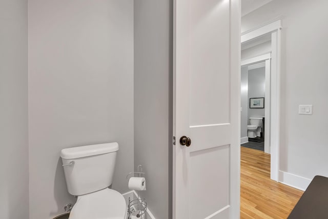 bathroom featuring toilet and wood-type flooring