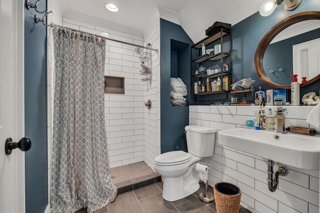 bathroom featuring curtained shower, toilet, and tile patterned floors