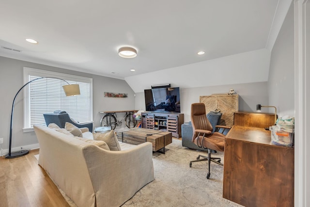 living room with light wood-type flooring and vaulted ceiling