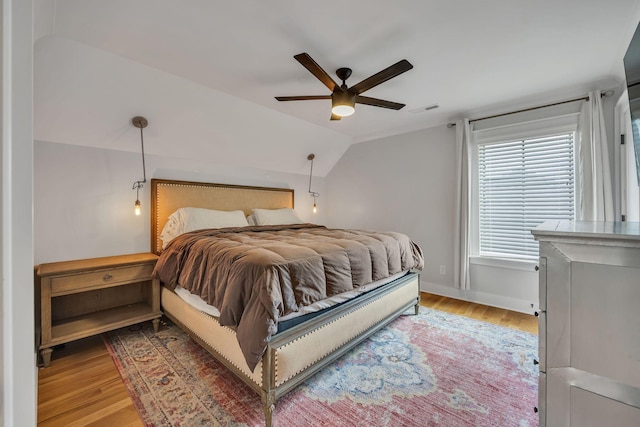 bedroom featuring lofted ceiling, ceiling fan, and light hardwood / wood-style flooring