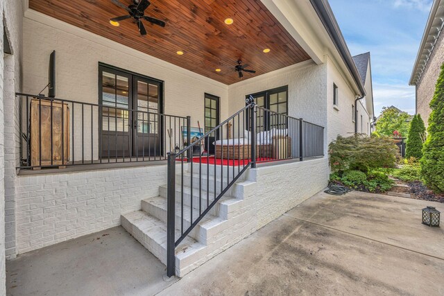 entrance to property featuring ceiling fan and a patio