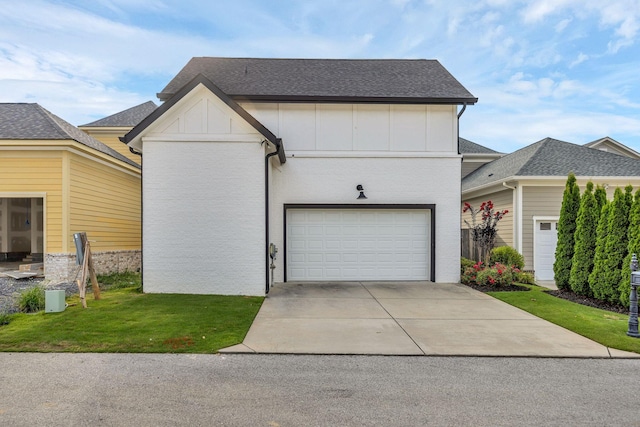 view of front of property featuring a garage and a front lawn