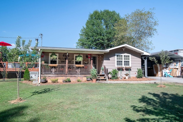 single story home featuring a porch, a carport, a front yard, and driveway