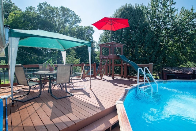 outdoor pool featuring outdoor dining area and a wooden deck
