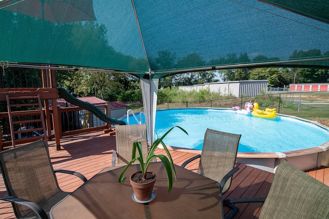 view of swimming pool with a wooden deck