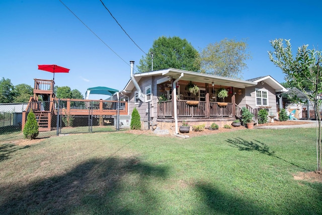 exterior space featuring a front lawn, fence, and covered porch