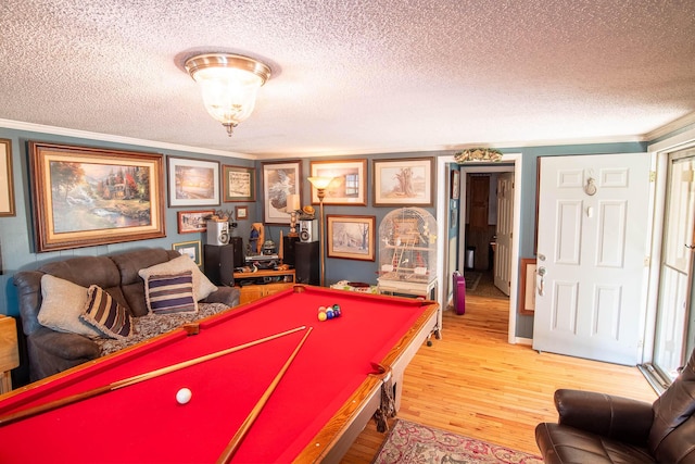 rec room with crown molding, billiards, wood finished floors, and a textured ceiling