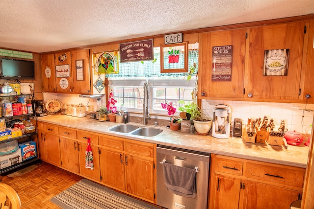 kitchen with light parquet flooring, a textured ceiling, stainless steel dishwasher, and sink