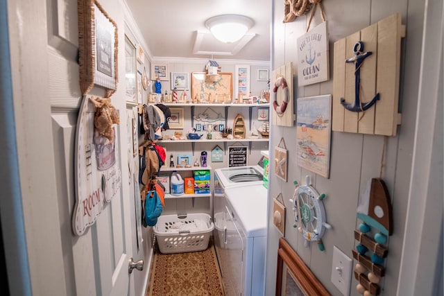 laundry room featuring washer and dryer, ornamental molding, and laundry area