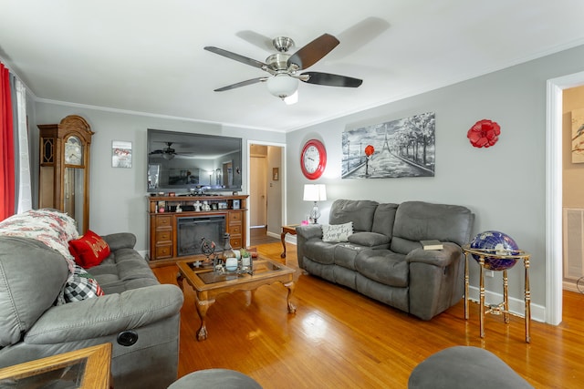 living room with ceiling fan, hardwood / wood-style flooring, and ornamental molding