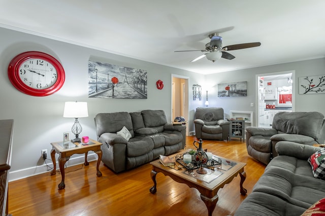 living room with ceiling fan, crown molding, and wood-type flooring