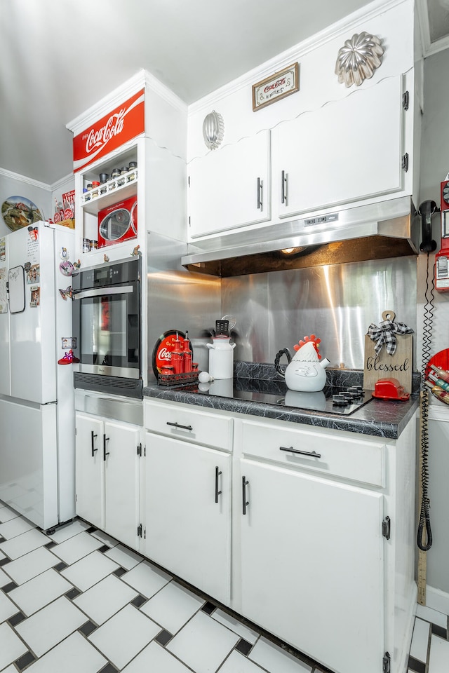 kitchen featuring ornamental molding, backsplash, oven, white refrigerator, and white cabinets