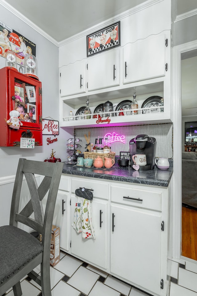 kitchen with ornamental molding and white cabinetry