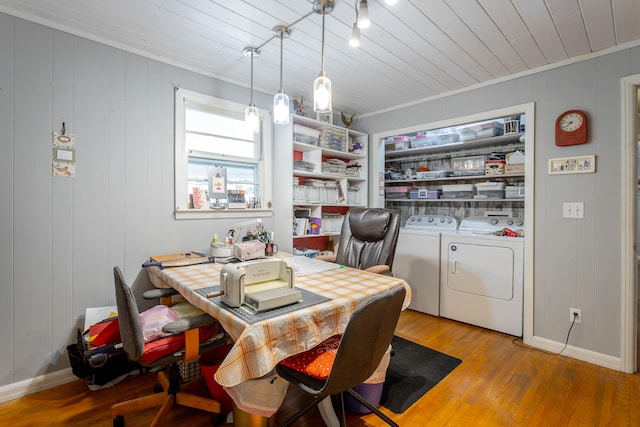 dining area with wood walls, light hardwood / wood-style floors, washer and dryer, wood ceiling, and ornamental molding